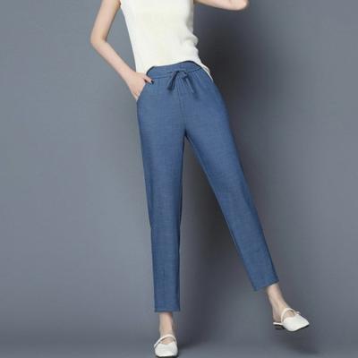 China Tencel breathable fabric jeans harem ladies elastic waist pants with self fabric string casual women's trousers for sale