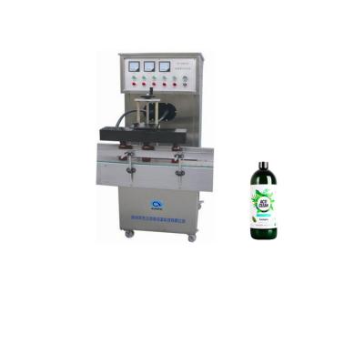 China Food Factory Supplied Vertical Shape Electromagnetic Induction Aluminum Foil Sealing Machine for sale