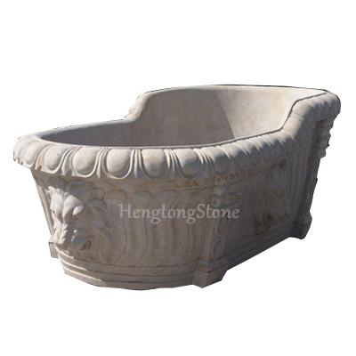 China Free Hand Carved Beige Marble Stone Bathtub With Lion Head for sale