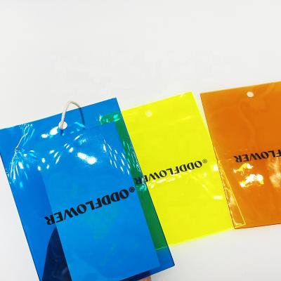 China Custom Viable Brand Logo Clothing Screen Print Colorful Plastic PVC Hanger Tag With String For Clothes Bags for sale