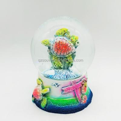 China Custom collectable snow globe REMEMBER hotel and sea turtle resort turtle souvenir lighthouse resin dolphin snow globe surf water globe for sale