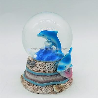 China Wholesale Custom Scenic Spot Life Island Beach Sea Ocean Snow Globe Africa Theme Water Globe Resin Animal Dolphin For Souvenir for sale