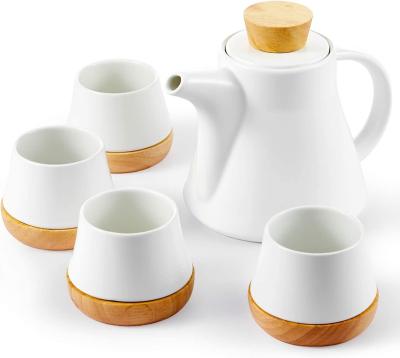 China 10-Piece White Ceramic Tea Set White Ceramic Teapot Set With Wooden Coasters Porcelain Teapot With Removable Stainless Steel Infuser For Loose Leaf for sale