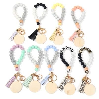 China Promotional Gift Monogram Silicone Beads Wooden Blank Key Ring Holder Customized Keychain Disc Wriselet Bracelet for sale