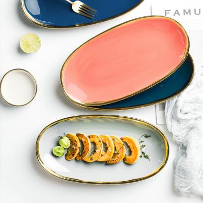 China Luster Tableware Sustainable Shiny Oval Shape Tapas Snack Ceramic Serving Dish With Gold Rim for sale