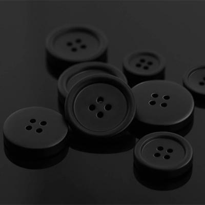 China Matte Black Resin Button washable in stock wholesale 11 15 18 20 23 25cm 4 holes garment coat button for sale