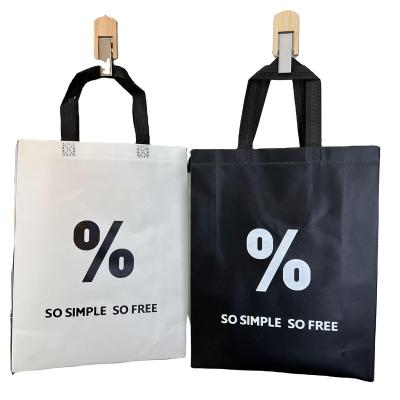 China 100% Eco-friendly Black And White Vertical Letters Nonwoven Laminated Tote Bag for sale