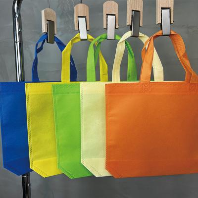 China Environment Friendly White Color Handled Nonwoven Tote Bag Can Be Customized Logo Advertising Bag for sale