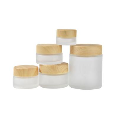 China Cheap Eco Friendly Personal Care Glass Cosmetic Cream Jars With Bamboo Lid for sale