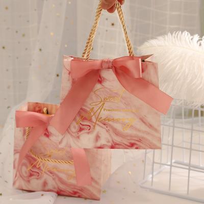 China Recyclable Wedding Candy Box Packaging Bag Wedding Candy Gift Bag With Hand Celebrity INS Paper Packaging Bag for sale