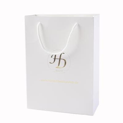 China New Logo Hot Foiled Stamping Black Matt Kraft Skin Care Paper Recyclable Gold Shopping Bag With Cotton Rope Handles for sale