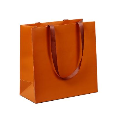 China Recyclable Custom Printing Orange Shopping Paper Bags With Ribbon Handle With Your Own Logo for sale