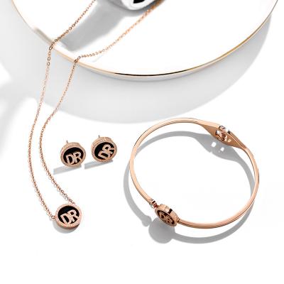 China Fashion non-allergic wholesale jewelry sets DR Letter Titanium Steel Rose Gold Necklace Earrings Bracelet set for sale