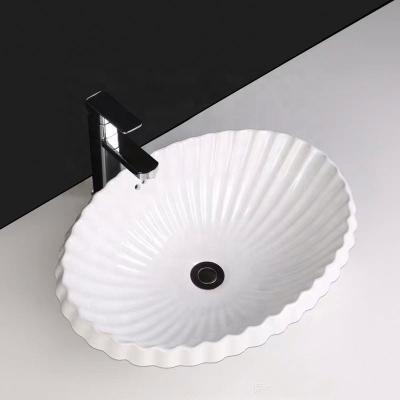 China Easy Clean Ceramic Bathroom Vanity Shell Pattern Oval Basin Undermount Sinks With Overflow Hole for sale