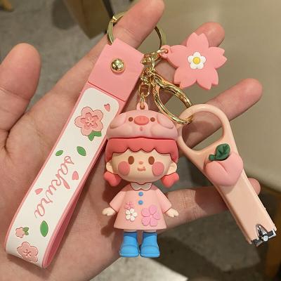 China Luxury Cute Cartoon Doll Cherry Blossom Designer Keychains Rubber Sakura Girly Pink Silicone Keychain with nail clipper for sale