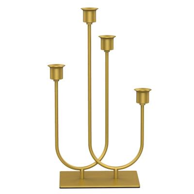 China Beautiful taper candle holder wedding by minimalist novelty fashion design dinner table centerpieces gold iron metal candlestick for sale