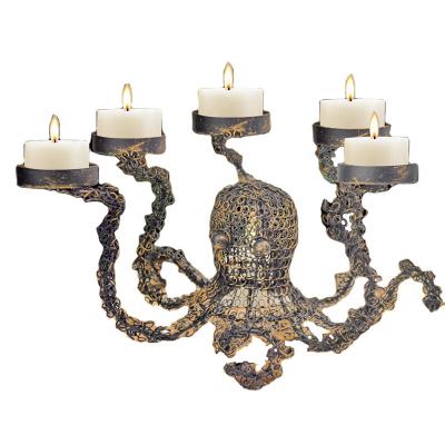 China Modern Graceful Fashion Hollow Out Rustic Design Octopus Gold Iron Metal Tealight Candle Holder Stand for sale