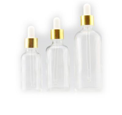 China Personal Care Essential Oil Bottle Sets Glass Bottle With Dropper Pink Cap Gold Cuticle Empty Cosmetic Oil Bottle for sale