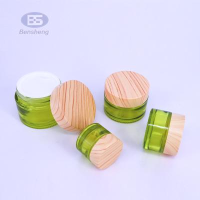 China order-friendly glass cosmetic jar and flat shoulder glass bottle with bamboo water transfer plastic lids for sale