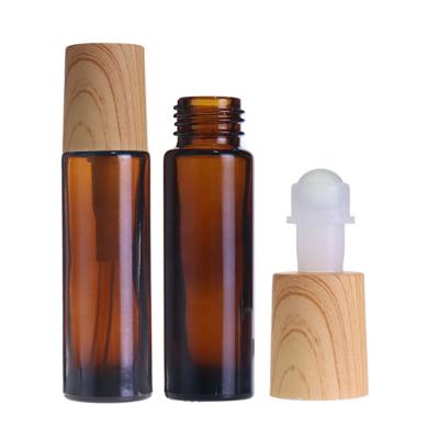 China 2021 hot sale cosmetic oil perfume 10ml 15ml clear transparent roll on roller glass bottle with bamboo lid and rollers for sale