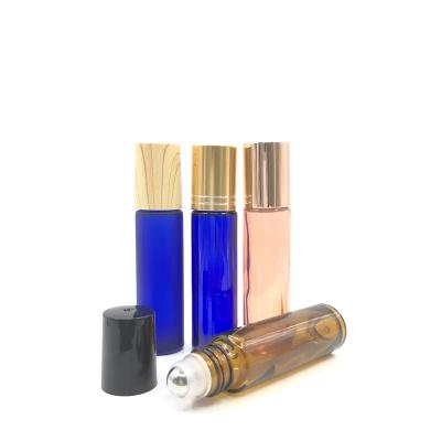 China 10ml Cosmetic Roll On Bottle Amber Blue Clear Glass Essential Oil Roll On Perfume Bottle With Trackball for sale