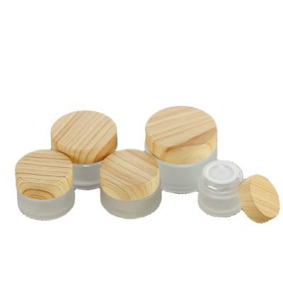 China Wholesale Cosmetic 5g 10g 15g 20g 25g 30g 50g 60g 100g Frosted Clear Glass Jar Bamboo Glass Cream Container for sale