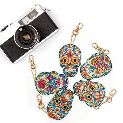 China Eco-Friendly New Product Ideas Skull Bone Shape Resin Double Side Sequins Painting Key Chain Set Weekly Deals 2021 for sale