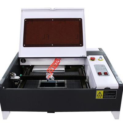 China New LH4040 50W CO2 laser water cooled cutting machine equipped with manual lifting platform for all kinds of non-metallic materials for sale