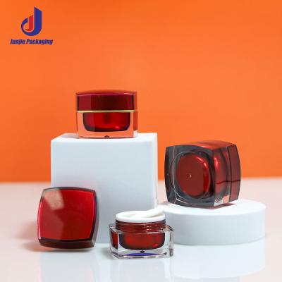 China Customized Plastic Cosmetic Bottles Square Acrylic Cosmetic Packaging Bottle Red For Eye Cream for sale