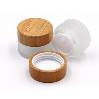 China Free sample 5g 15g 30g 50g 100g OEM ODM logo clear skin care cream/gel cosmetic glass jar with bamboo/wooden lid for cream container for sale