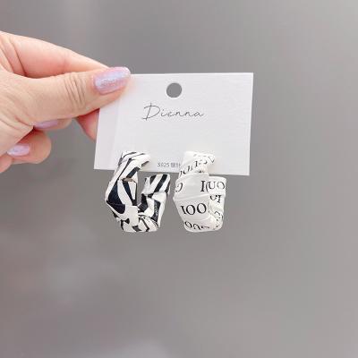 China New 925 fashionable pu leather earrings English alphabet silver needle temperament circle female 2021 earrings wholesale for sale