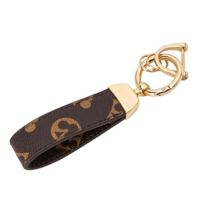 China New fashion key chain flower logo leather waist pendant with male and female metal key chain car key ring clasp for sale