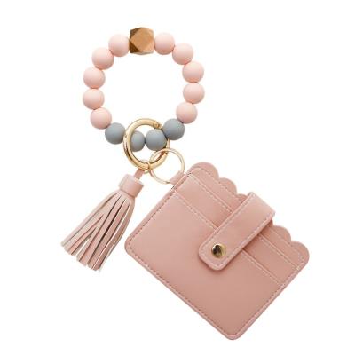 China New Unisex Silicone Bead Key Chain PU Tassel Map Silicone Wristband Wooden Keychain for sale