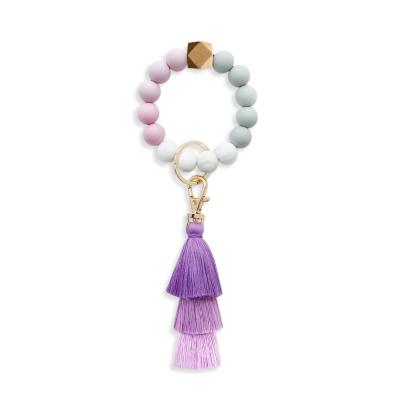 China Unisex Silicone Tassel Wooden Bead Bracelet Keychain Key Chain Pendant for sale