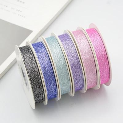 China Popular Boutique Wholesale High Tenacity 15mm Luster Glitter Ribbon Luminous Ribbon Factory for sale