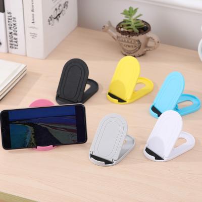 China Custom Logo Mobile Phone Tablets Lazy Adjustable Promotional Cell Phone Accessories Bracket Phone Holder Stand for sale