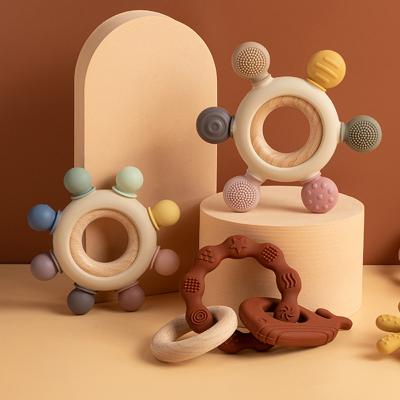 China Custom Free Silicone And Wood Newborn Wooden Teether Logo Round Shape Rudder Bpa Ring Funny Toys Baby Soothing Teething Toy for sale