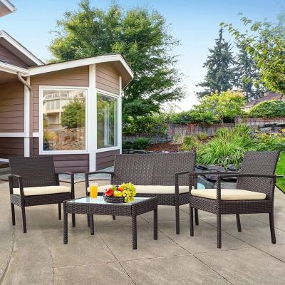 China Best Modern Hot Selling Rattan Set With Cushions Rattan Table And Chairs 4 Piece Set Low Price for sale