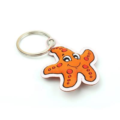 China Custom Twill Cheap Price Private Label Machine Woven Logo Cartoon Fabric Keychain With Star Animal Shape for sale