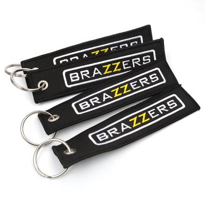 China Hot Sale Fashion Pipeline Tag Machine Custom Black Twill Punk Embroidered Apparel Keychains With Letters Logo for sale