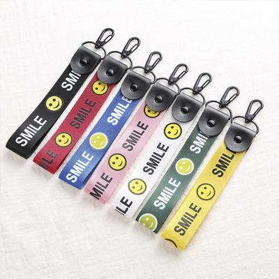 China Advertising Colorful Logo Key Chains Safety Woven Custom Cute Smile Face Printing Silk Screen Design Bracelet For Gifts for sale