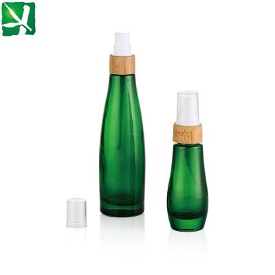 China Eco-friendly 30ml/100ml green pyriform glass lotion bottle with bamboo pump, bamboo cosmetic packaging for sale