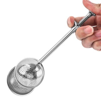 China Viable Kitchen Tool Stainless Steel Tea Ball Handle Push Tea Strainer Long Teapot Ball Shaped Mesh Tea Infuser for sale