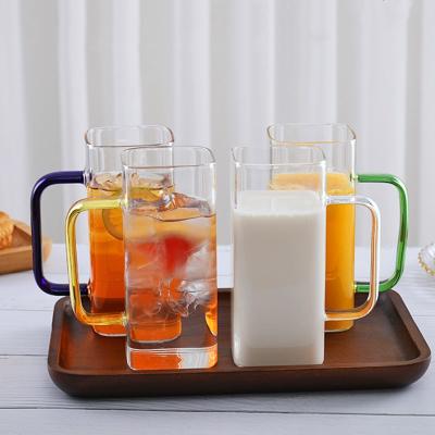 China High Sustainable Borosilicate Glass Hot Mug With Colored Handle For Milk Juice Water Beer for sale