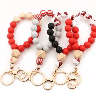 China 2021 Amazon Christmas Style Jingle YI Designs Beaded Bracelet Tassel Silicone Wristband Key Chain Key Chain For Women for sale