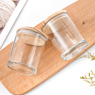 China 2023 Home Decoration Custom Glass Candle Jar New Candle Cups Clear Glass Candle Jars With Wood Lid for sale