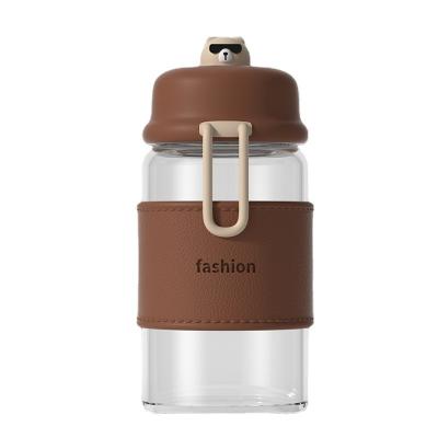 China Sustainable SARTLII Student Minimalist Mini Portable Bear Design Borosilicate Cute Glass Water Bottle With Leather Sleeve for sale