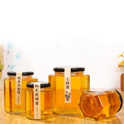 China Home Kitchen Factory Directly Sell Hexagon Mini Glass Honey Jars With Wooden Diver And Gold Lid for sale