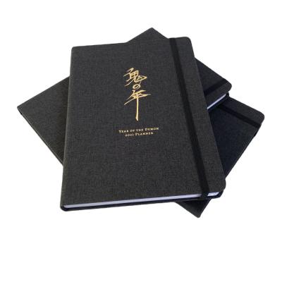 China Custom colorful embossed spiral logo luxury fabric cover A5 journal planner hard canvas notebooks for sale