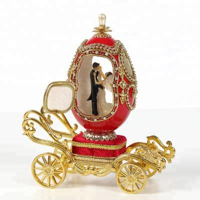 China Romantic Europe Carriage Shape Faberge Egg Carving Music Box for sale